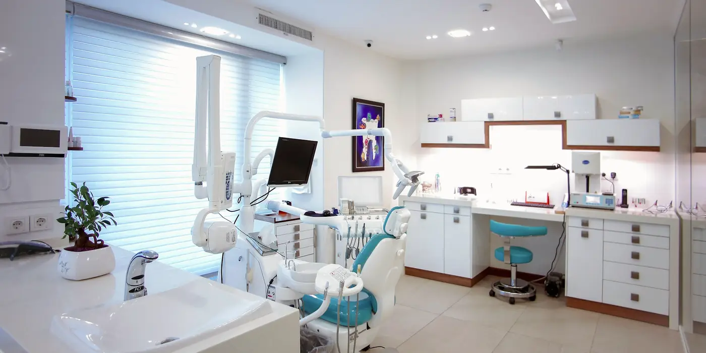 Modern, bright dental treatment room with a patient chair