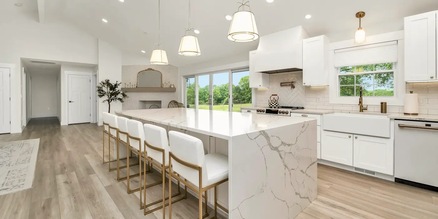Bright kitchen with a marble island and white cabinets